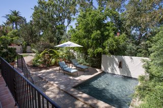 Just Listed at $4M, This Spanish Colonial Revival in Southern California Promises Resort-Like Living - Photo 6 of 8 - A separate structure houses a state-of-the-art gym and spa with a steam shower and a massage room. The bi-fold doors of the spa open to a tranquil reflection pool and sun deck. 