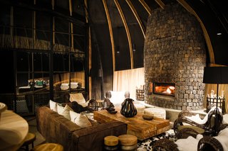 Take an Eco-Escape to a Spherical Forest Villa in an Eroded Volcanic Cone in Rwanda - Photo 8 of 10 - The volcanic mountainous terrain also resonates in the volcanic stone that's used in Bisate’s fireplaces and its surrounds, while natural ‘flamed’ granite is used for many surfaces.