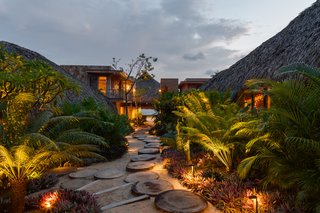 This Expansive Beachside Home on Mexico's Pacific Coast Puts a Modern Spin on Tradition - Photo 1 of 13 - Each of the smaller pavilions is nestled into the landscape of native vegetation and is set along a path that's connected by stepping stones made out of cut tree trunks. 