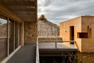 This Expansive Beachside Home on Mexico's Pacific Coast Puts a Modern Spin on Tradition - Photo 9 of 13 - The thatched palapa roof is juxtaposed with the modern structure, putting a contemporary spin on tradition. 