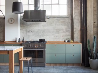 Modern Kitchen Upgrade Ideas From a Danish Design Firm That's Challenging the Kitchen Market - Photo 4 of 8 - Another customization includes a basis Linoleum in olive with handles, edges, and countertops done in natural oak, which softens the look of this industrial concrete kitchen in Long Beach, California. 
