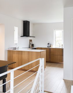 Modern Kitchen Upgrade Ideas From a Danish Design Firm That's Challenging the Kitchen Market - Photo 6 of 8 - For this home in Copenhagen, this design by Henning Larsen Architects was customized in oak veneer with a copper strip and is complemented by a white Corian countertop.