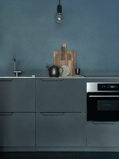 Modern Kitchen Upgrade Ideas From a Danish Design Firm That's Challenging the Kitchen Market - Photo 2 of 8 - Larsen's kitchen design was also used for the head office of Danish interior and design house Broste Copenhagen. Founded in 1955, Broste is one of Scandinavia's biggest interior design brands. Their kitchen has been customized with aluminum in the color anthracite and paired with a steel countertops. The kitchen is simple, but exclusive in its timeless design. With no handles, it presents a sleek, seamless surface. The materials, which have seldom been used in kitchens, present a clean but raw expression.