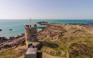 8 Unique Vacation Rentals Around the World - Photo 13 of 16 - Set on a cliff top overlooking Corbière lighthouse on Jersey's south-west tip, the Radio Tower covers six floors and boasts a stunning 360-degree view. Built during the Second World War by German Occupying Forces, the Radio Tower is one of Jersey's most iconic sites standing on the south-west tip of Jersey's shoreline. Restored in a German modernist Bauhaus style, with a concrete staircase winding up six floors through the center of the building and leading to a wooden spiral staircase to the top floor. Original features include observation slots on the seaward side and steel doors on the ground floor. <span style="color: rgb(204, 204, 204); font-size: 13px;">TripAdvisor Rentals</span>