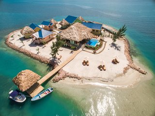 8 Unique Vacation Rentals Around the World - Photo 15 of 16 - Powered by a state-of-the-art solar power system, you can literally go off the grid at this private island in Belize. The uniquely designed compound home includes five private suites specifically laid out to take advantage of the amazing sea and mountain views and the cool trade winds off the Placencia Peninsula in southern Belize.