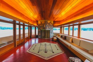 A Home on a Private Island That's Based on a Frank Lloyd Wright Design Is on the Market For $14.9M - Photo 5 of 14 - Large windows wrap around the home's exterior, offering stunning views from every room. It also features six wood-burning fireplaces. 