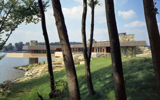 A Home on a Private Island That's Based on a Frank Lloyd Wright Design Is on the Market For $14.9M - Photo 14 of 14 - The home extends over the rocky shore of the island in a way that's reminiscent of Wright's Fallingwater. 