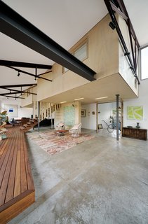 A 1960s Melbourne Warehouse Is Upcycled and Transformed Into an Energy-Efficient Family Home - Photo 4 of 11 - Mezzanine-level rooms float within the original volume of the warehouse. The existing floor slab was also preserved, partially due to restricted site access, but also for its inherent character.