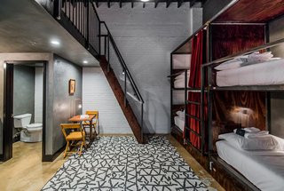 A New Experiential Hostel in Austin Offers Unique Lodging in a Restored Railway Hotel - Photo 8 of 16 - The bunk beds in the communal "Loft Room" are tucked into handcrafted bunks complete with privacy curtains, a lamp, and plug.