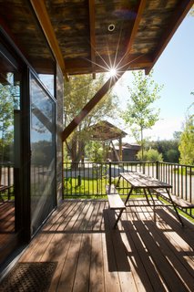 Test Out Tiny House Living at One of These Nature-Immersed Cabin Resorts - Photo 2 of 14 - The outdoor deck on the Caboose cabins