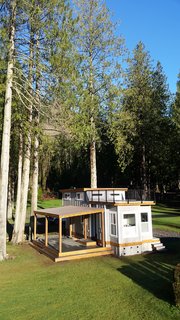 Test Out Tiny House Living at One of These Nature-Immersed Cabin Resorts - Photo 14 of 14 - The Flat Roof Caboose design features a loft that can accommodate two beds. Windows give the loft area an open-air feel with an abundance of light. The front of the cabin opens to a private deck. Exteriors are covered with a mix of metal and wood-tone siding for a contemporary finish. 