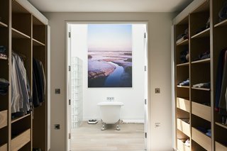 Historic Gasworks Cottage With a Modern Cor-Ten Steel Addition Hits the Market - Photo 8 of 9 - The master bedroom suite also includes a spacious dressing room that leads to the en suite bath.
