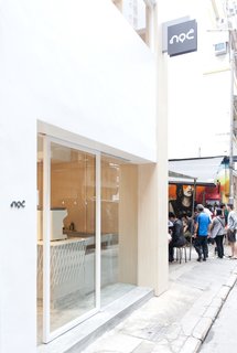 A Sleek Coffee Shop in Hong Kong With Beautiful, Minimalist Interiors - Photo 1 of 9 - The minimalist facade of Noc Coffee Co. on Gough Street sets it apart from the busy, urban street scene. 