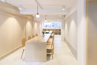 A Sleek Coffee Shop in Hong Kong With Beautiful, Minimalist Interiors - Photo 7 of 9 - The second floor features two communal tables that can be pushed together to form one long table for special events. 