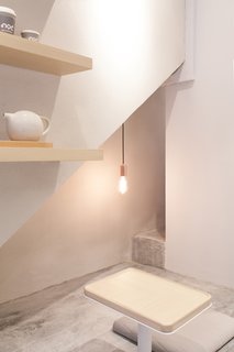 A Sleek Coffee Shop in Hong Kong With Beautiful, Minimalist Interiors - Photo 5 of 9 - The cozy seating nooks are perfect for enjoying a cup of coffee and a book. 