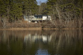 Experience Cape Cod Modern by Staying at the Midcentury Weidlinger House - Photo 1 of 8 - Anchored on concrete piers at the higher end of the slope, the house shoots out over stilts, suspended in midair for a commanding view of Higgins Pond. 