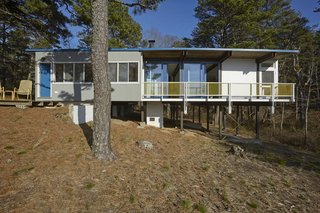 Experience Cape Cod Modern by Staying at the Midcentury Weidlinger House - Photo 3 of 8 - The four-foot-deep veranda wraps around three sides of the house’s public wing, shading it from the hot rays of the sun by an equally deep eave. 