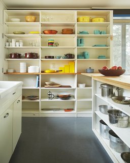 Experience Cape Cod Modern by Staying at the Midcentury Weidlinger House - Photo 7 of 8 - The kitchen's open shelving serves as a colorful display for midcentury-modern cookware. 