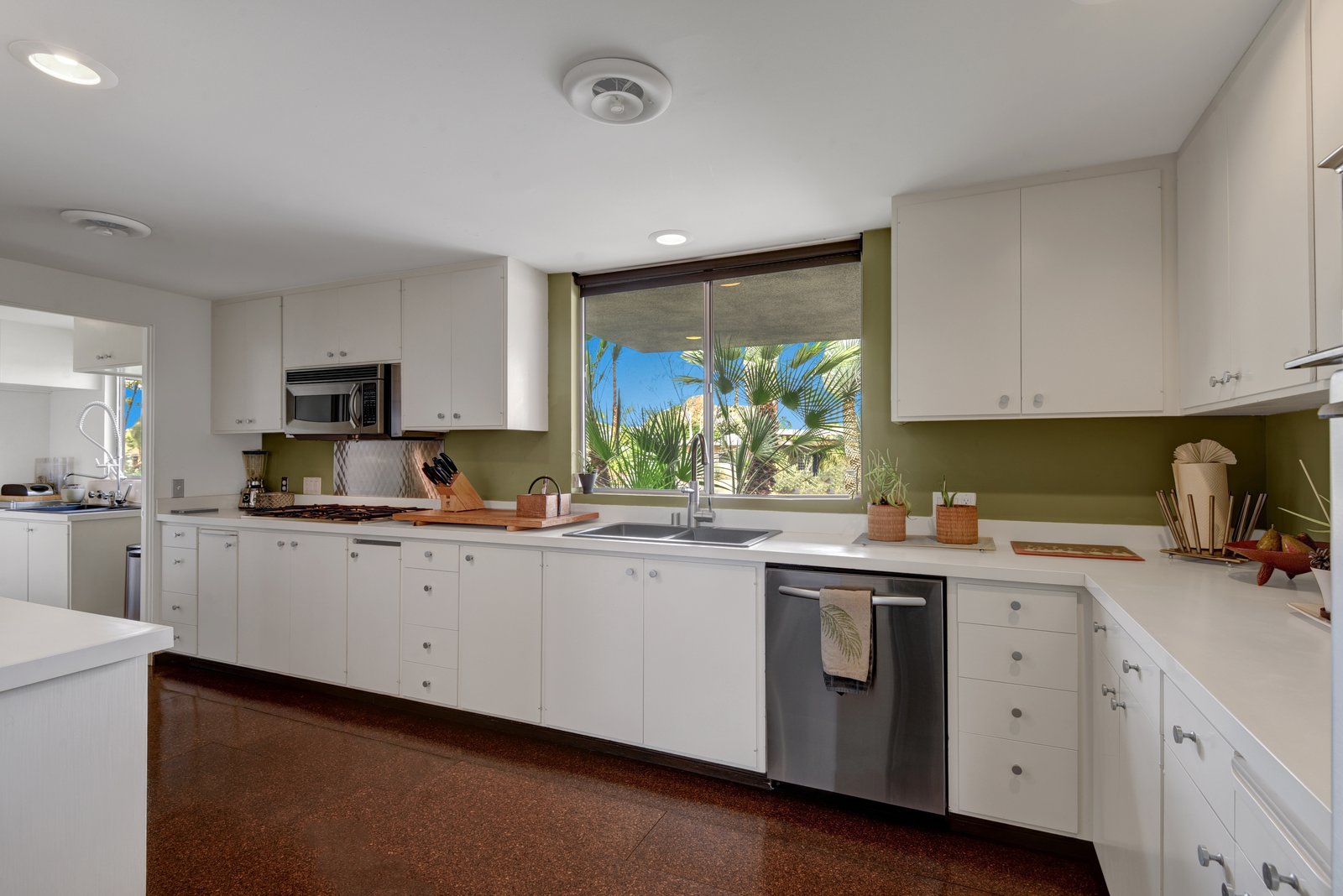 The kitchen and prep kitchen feature stainless steel appliances, commercial fixtures, and cork floors.
