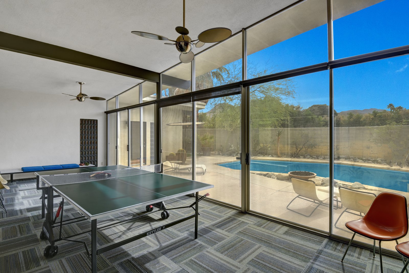 A bonus area overlooks the pool and is currently being used as a game room.