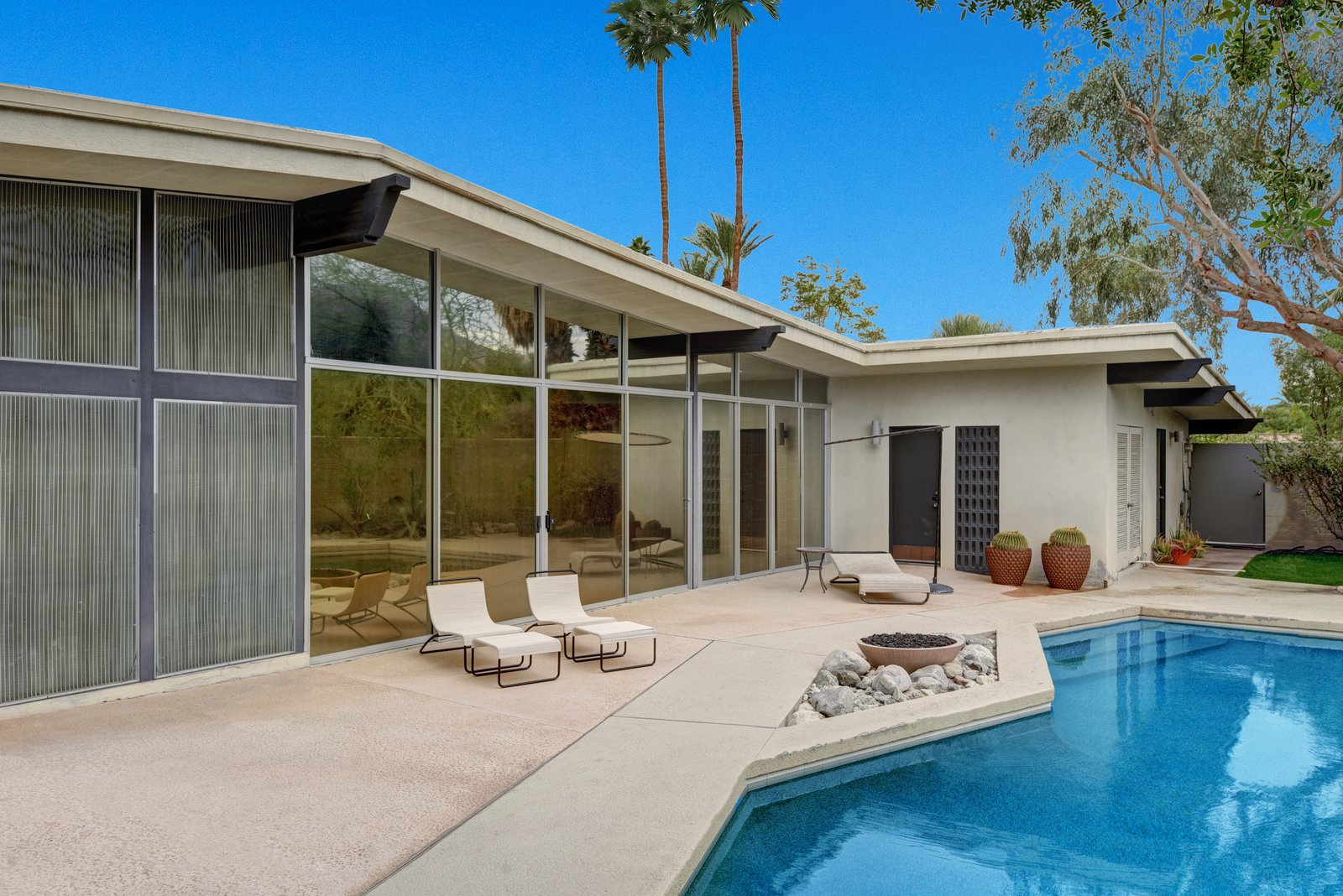 The pool area showcases a Pebble-tec saltwater pool, fountain, succulent garden, and firepit.