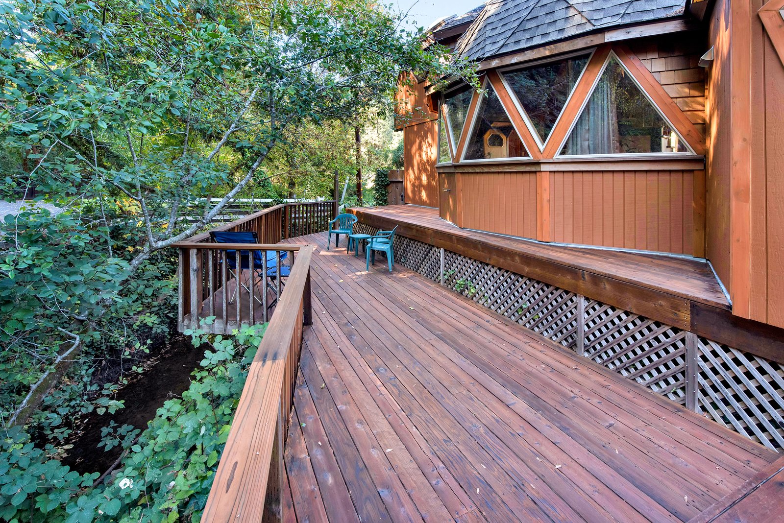 The deck looks out over a forested section of land.