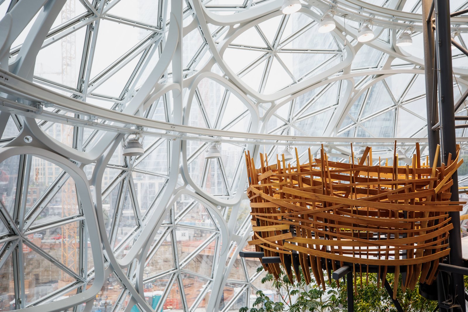 In addition to the plants themselves, the interior also includes tree houses, bridges, a waterfall and a conference room enclosed by greenery.