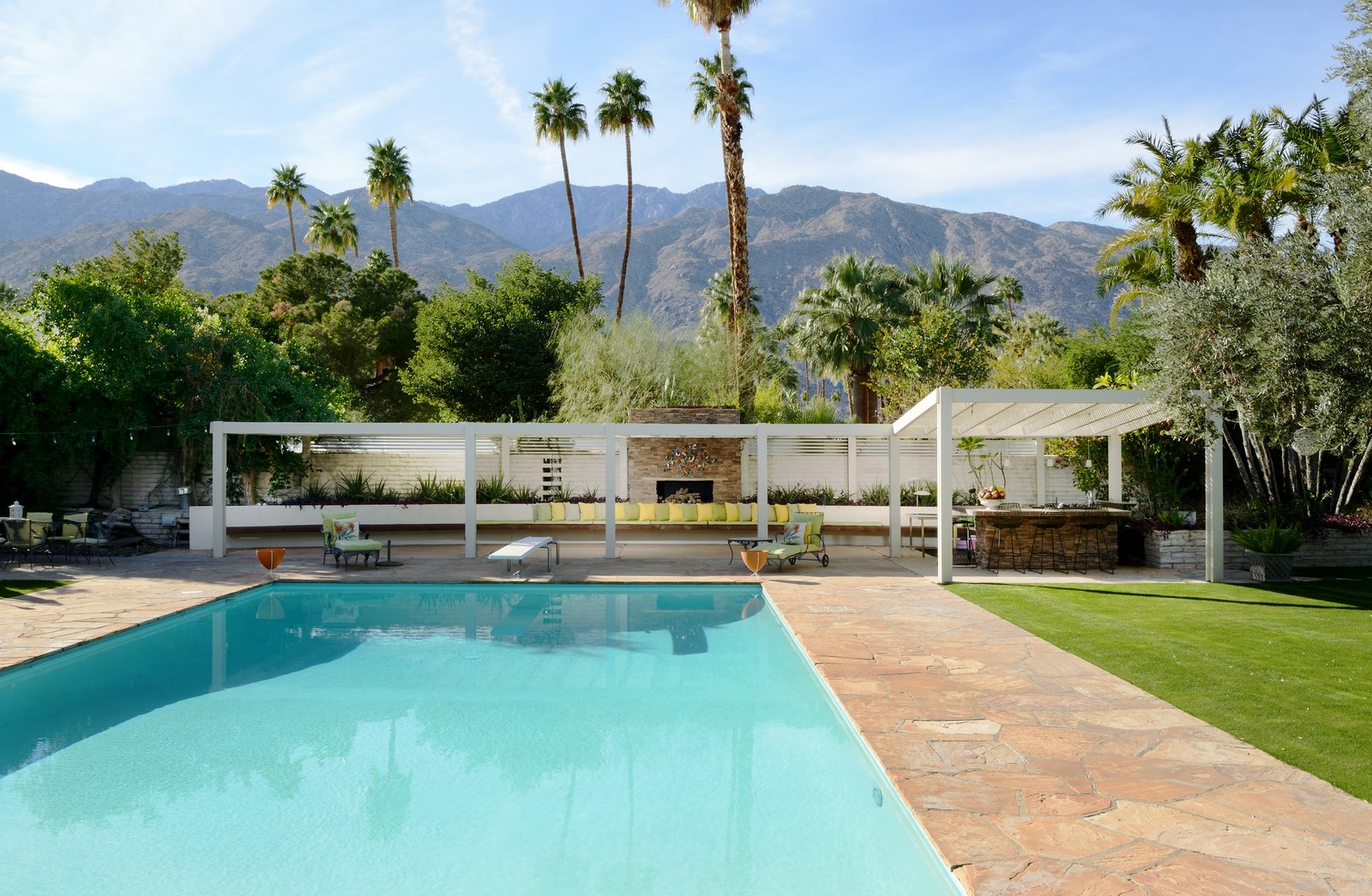 The outdoor entertaining space includes a shuffleboard court and built-in outdoor seating area complete with a fireplace and barbecue.