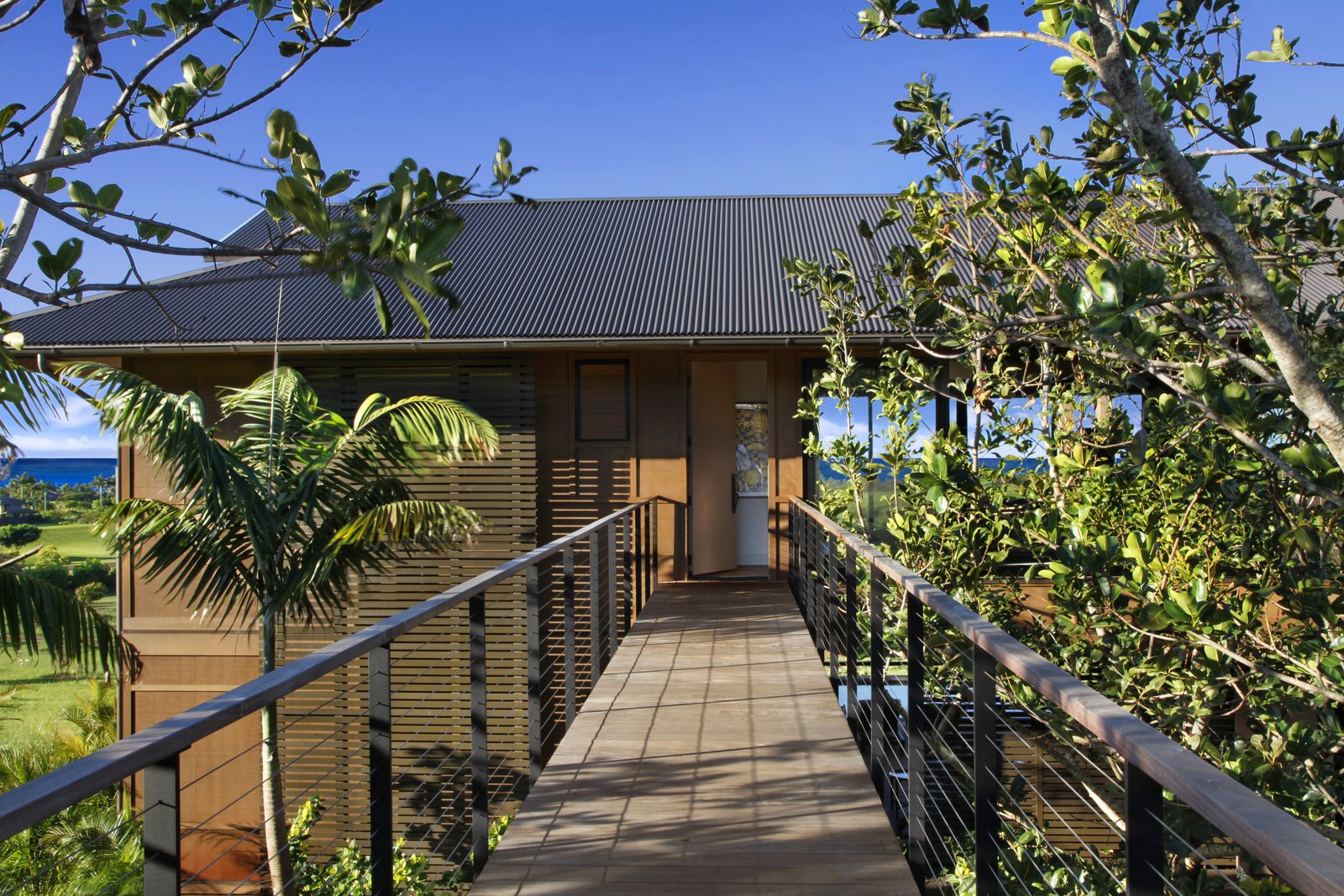 The resort-like residence has midcentury modern influences, with a strong tropical vibe.