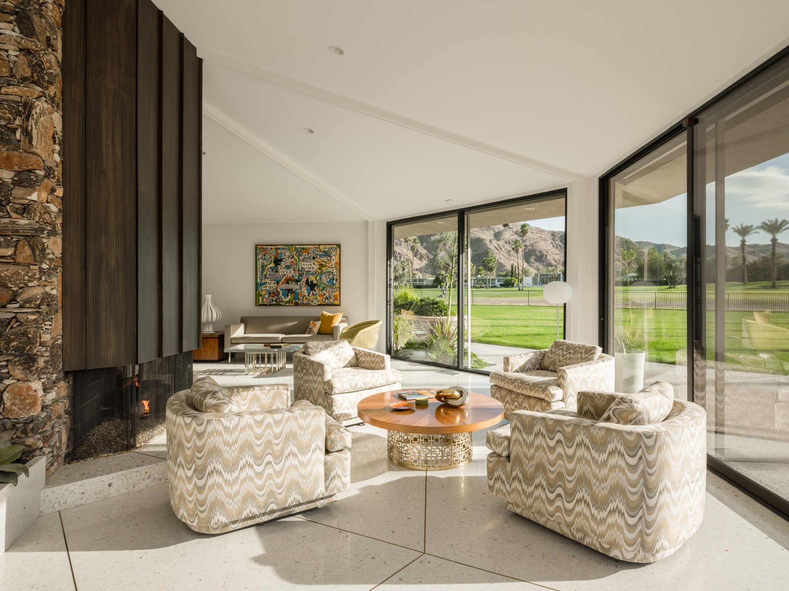 An alternate view of the living space and wood-paneled fireplace.