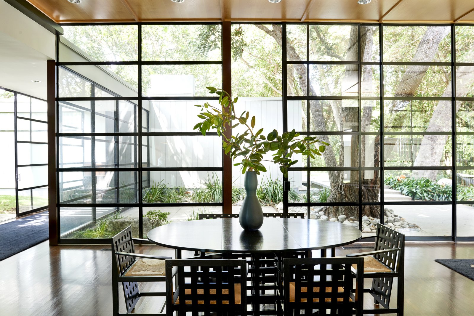 The glass wall of windows lets in plenty of natural light.
