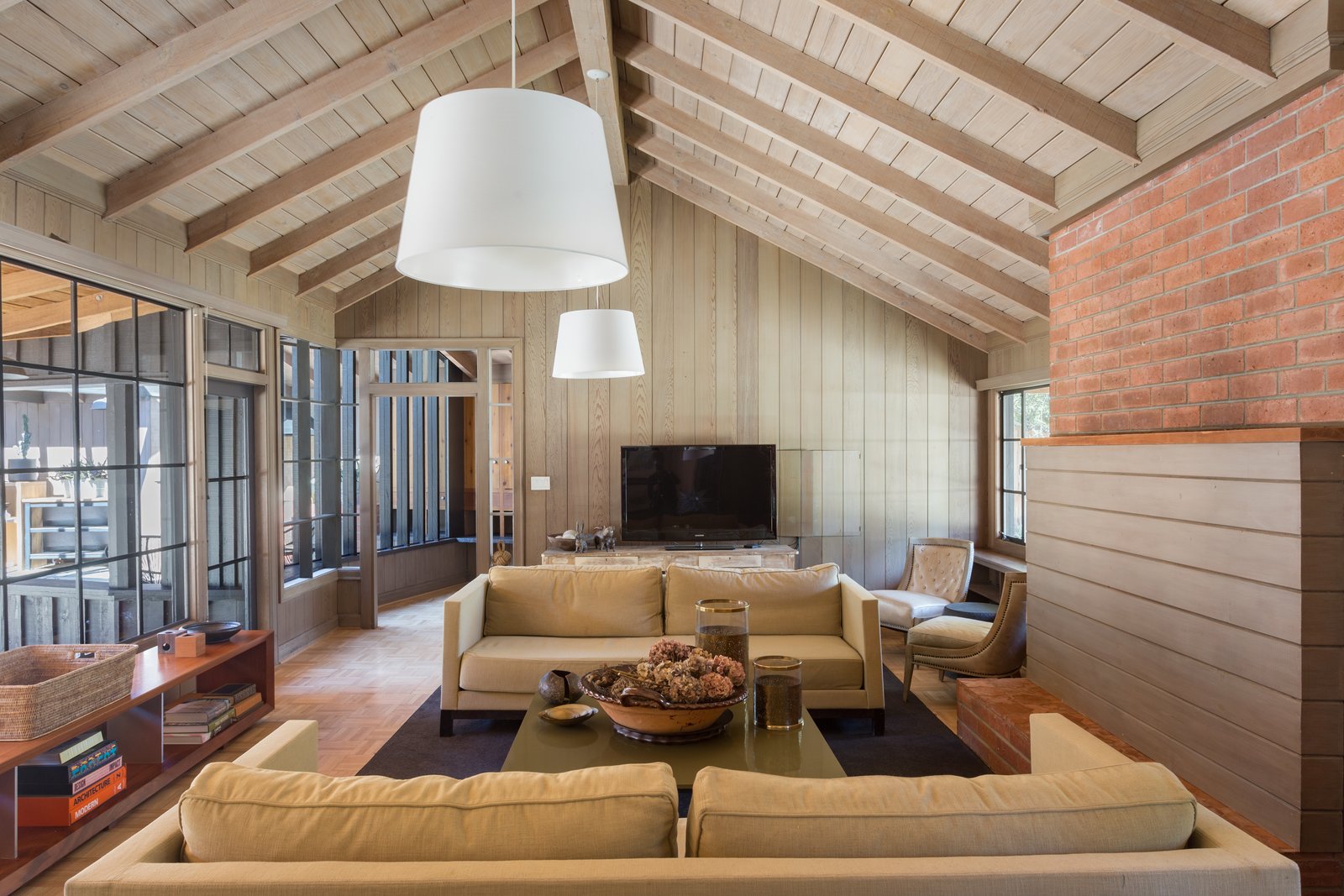 With original steel-framed windows, beamed ceilings, warm wood-paneled walls, and a gracious floor plan it makes for a wonderful entertaining space.