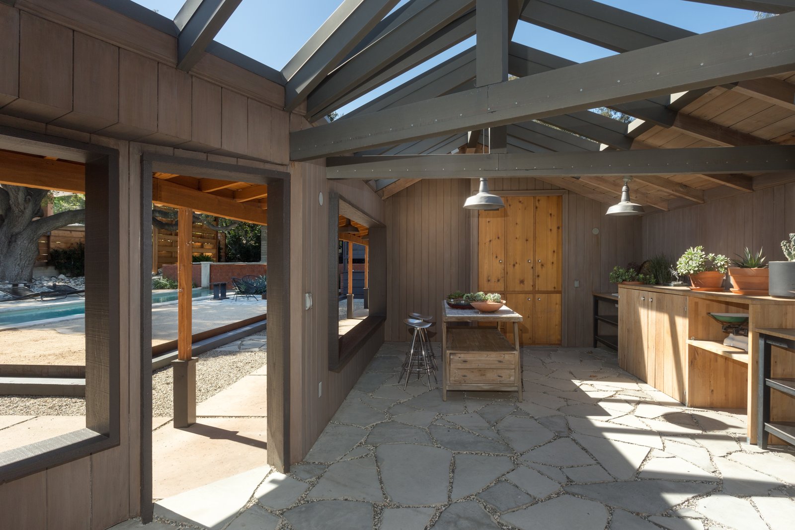 With original steel-framed windows, beamed ceilings, warm wood-paneled walls, and a gracious floor plan it makes for a wonderful entertaining space