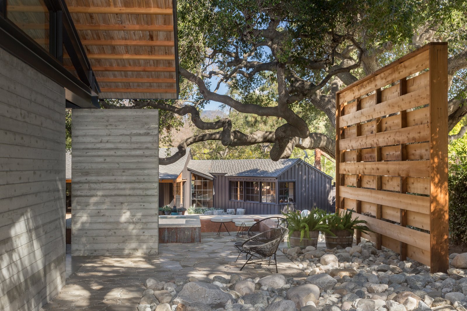 An original 1957 California Ranch by Kemper/Nomland has been painted black and transformed into a pool/guest house.