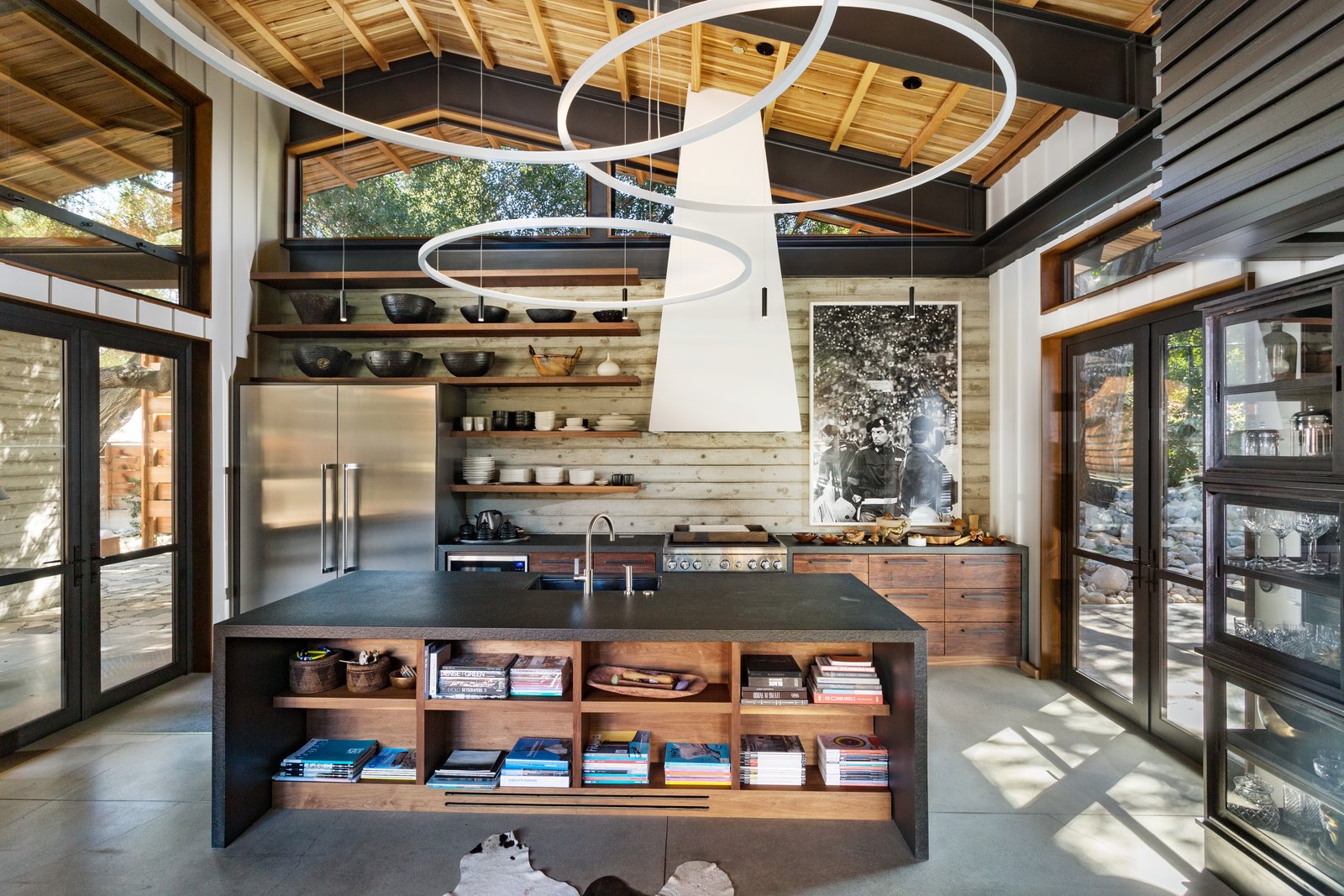 e open chef's kitchen features custom crafted cabinetry, a commercially sized pantry and an epic island of mallet stamped stone. It also benefits from ample glazing allowing for plenty of natural light.