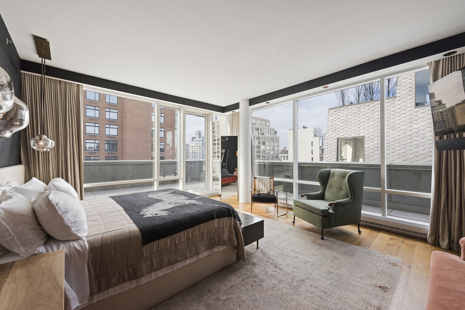 The master bedroom features floor-to-ceiling windows and terrace access as well as a deluxe ensuite bathroom.