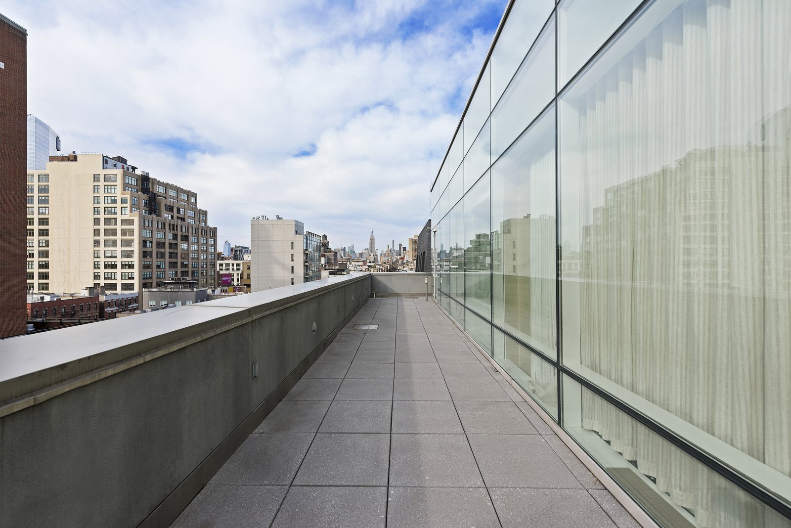 A terrace wraps around the perimeter of the unit.