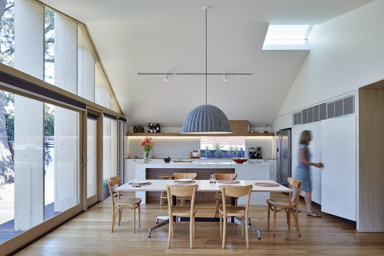 Strategically placed openings and an automated roof window at the apex of the slanted ceiling can be opened to release hot air during the summer months.