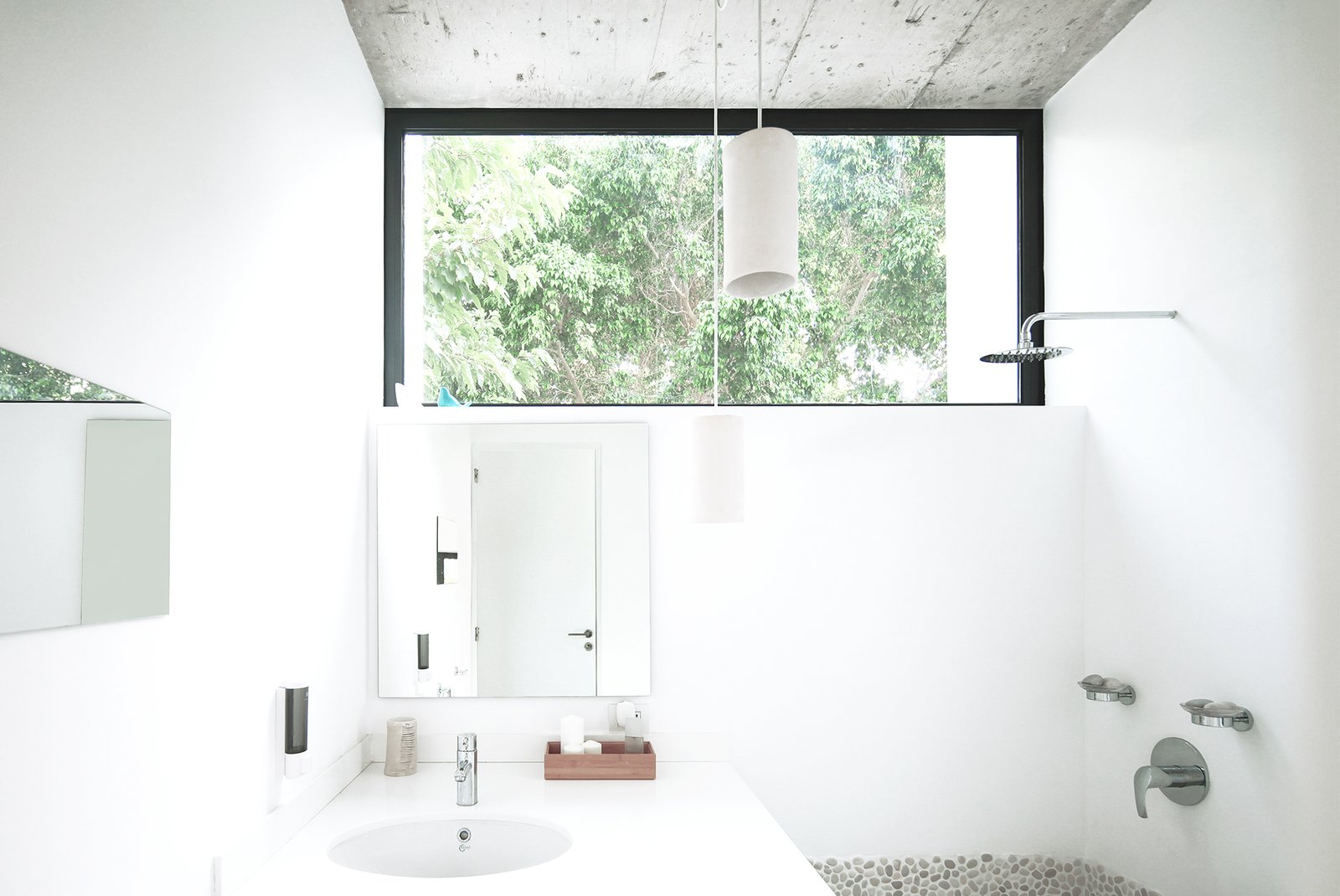 The bathroom maintains a sense of outdoor living with the large clerestory window.