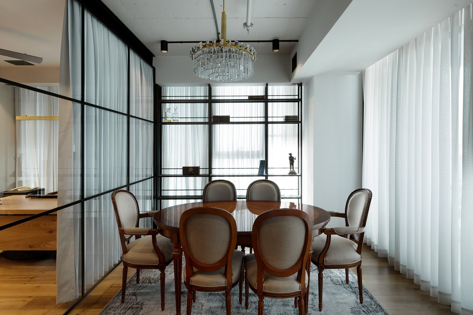 The home's industrial look is softened by vintage elements throughout and curtains.