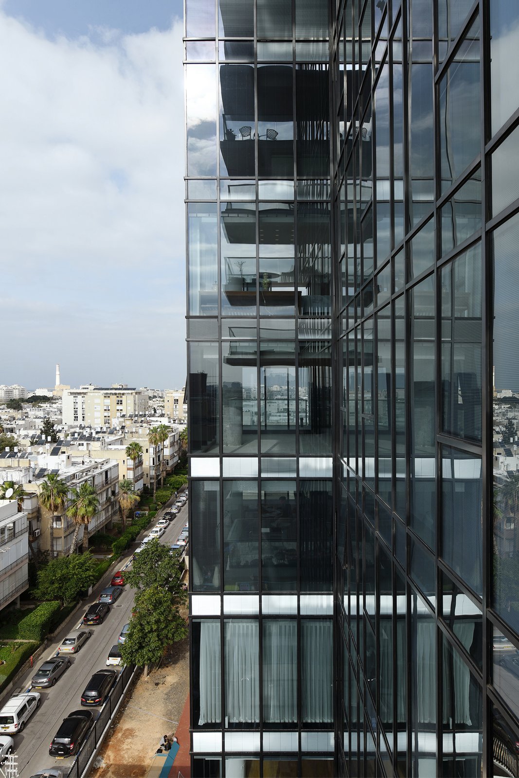 The exterior of the modern glass tower in Tel Aviv.
