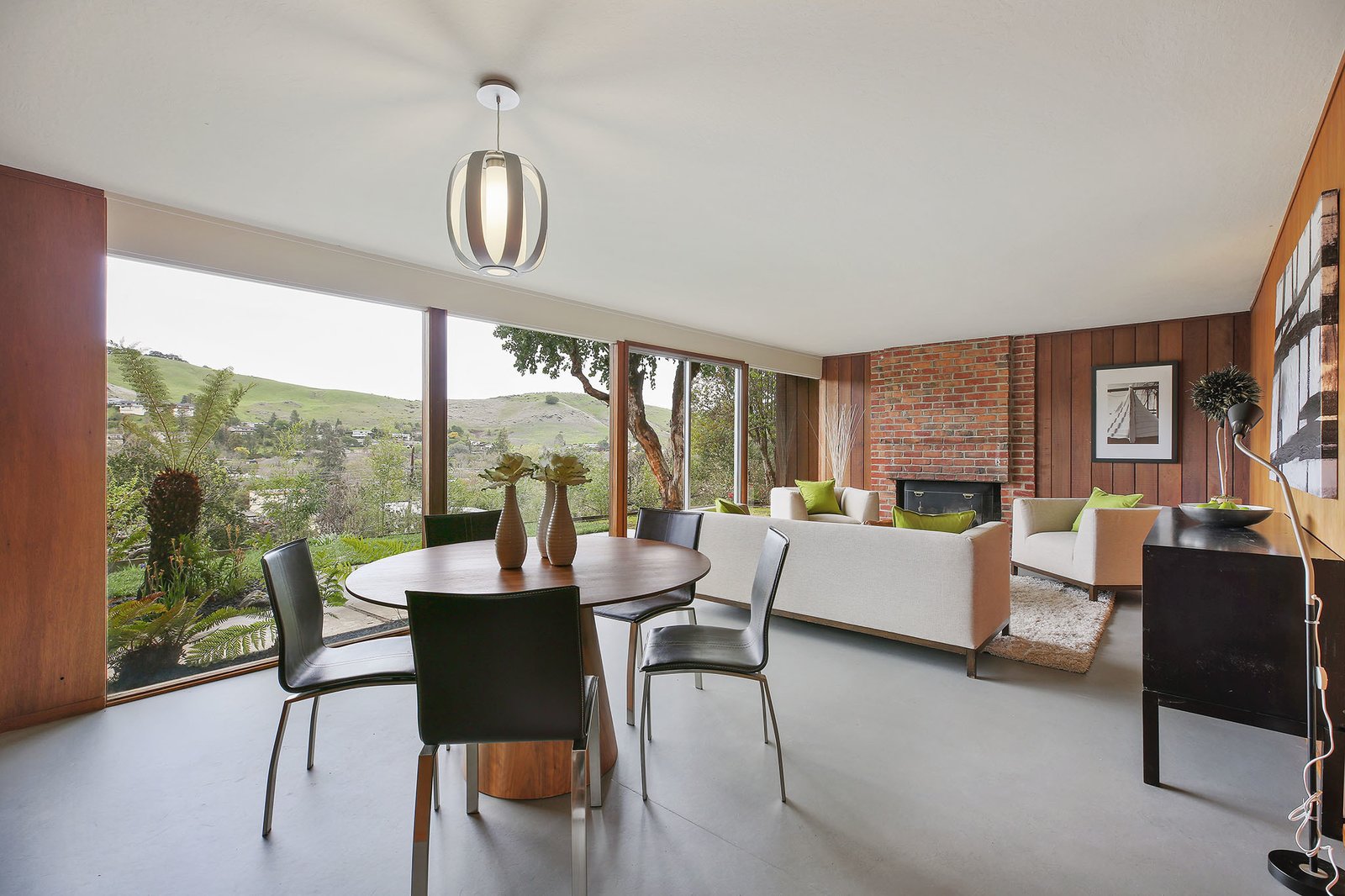 The spacious open living/dining room has an original wood burning fireplace.