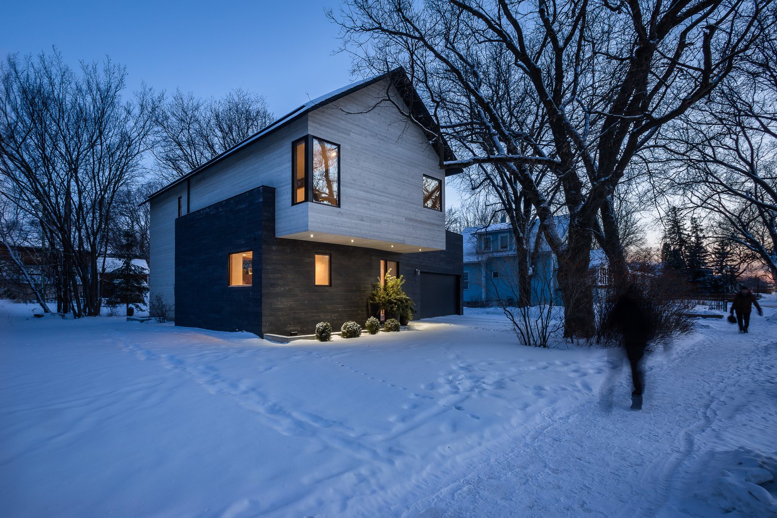 The home's contemporary profile shows a sensitivity to the adjacent established homes, many of which sport Victorian-style roofs.