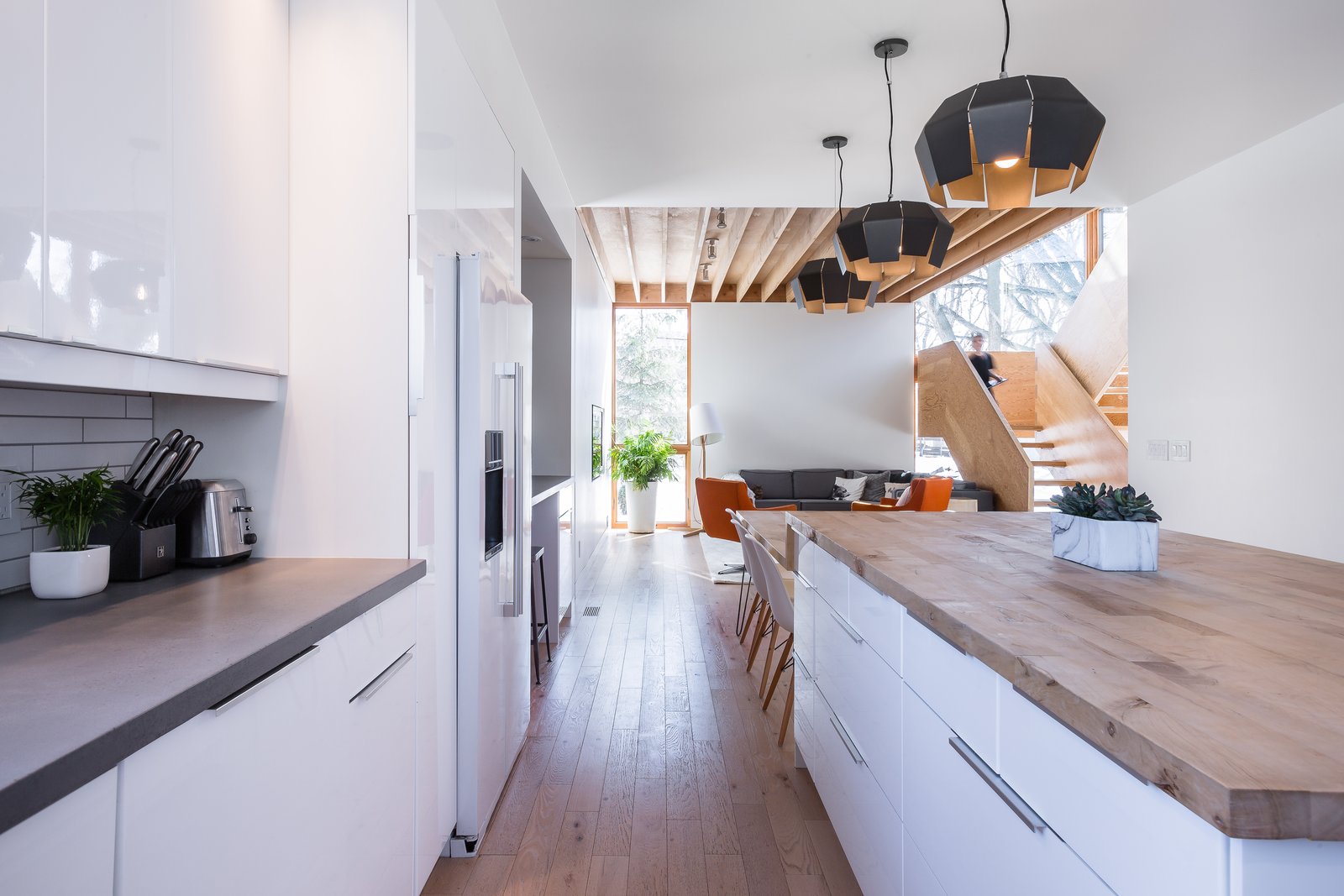 The footprint of the home was configured to accommodate all of the existing trees without risking damage to their roots. An exception was made for a tree which sat in the middle of the property which was showing signs of decay. A dense Canadian Maple, the tree was milled and repurposed as the central island/dining room table—also built by Duerksen himself—and is now located only 10 feet from its original location.