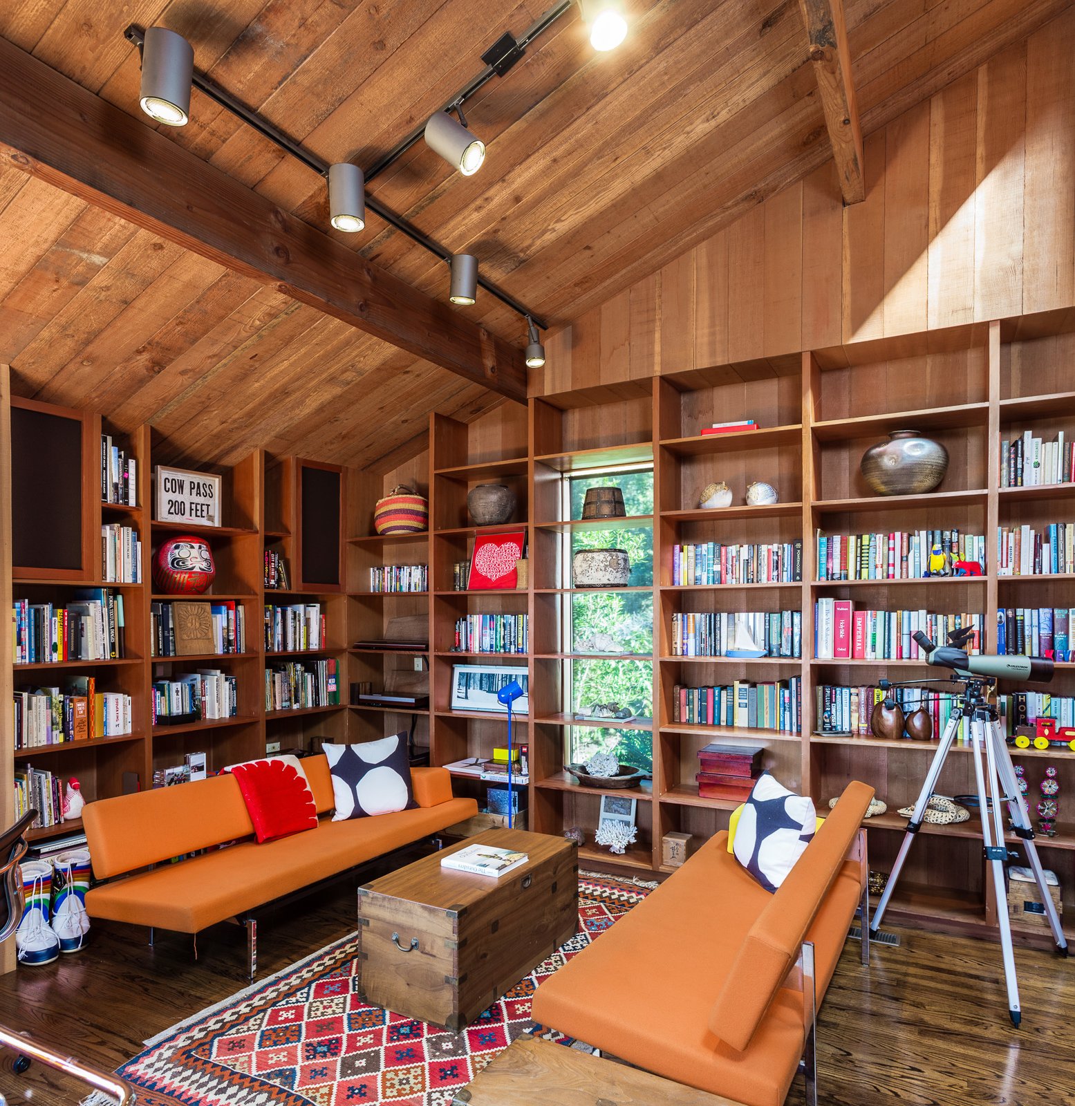 A den filled with built-in bookshelves.