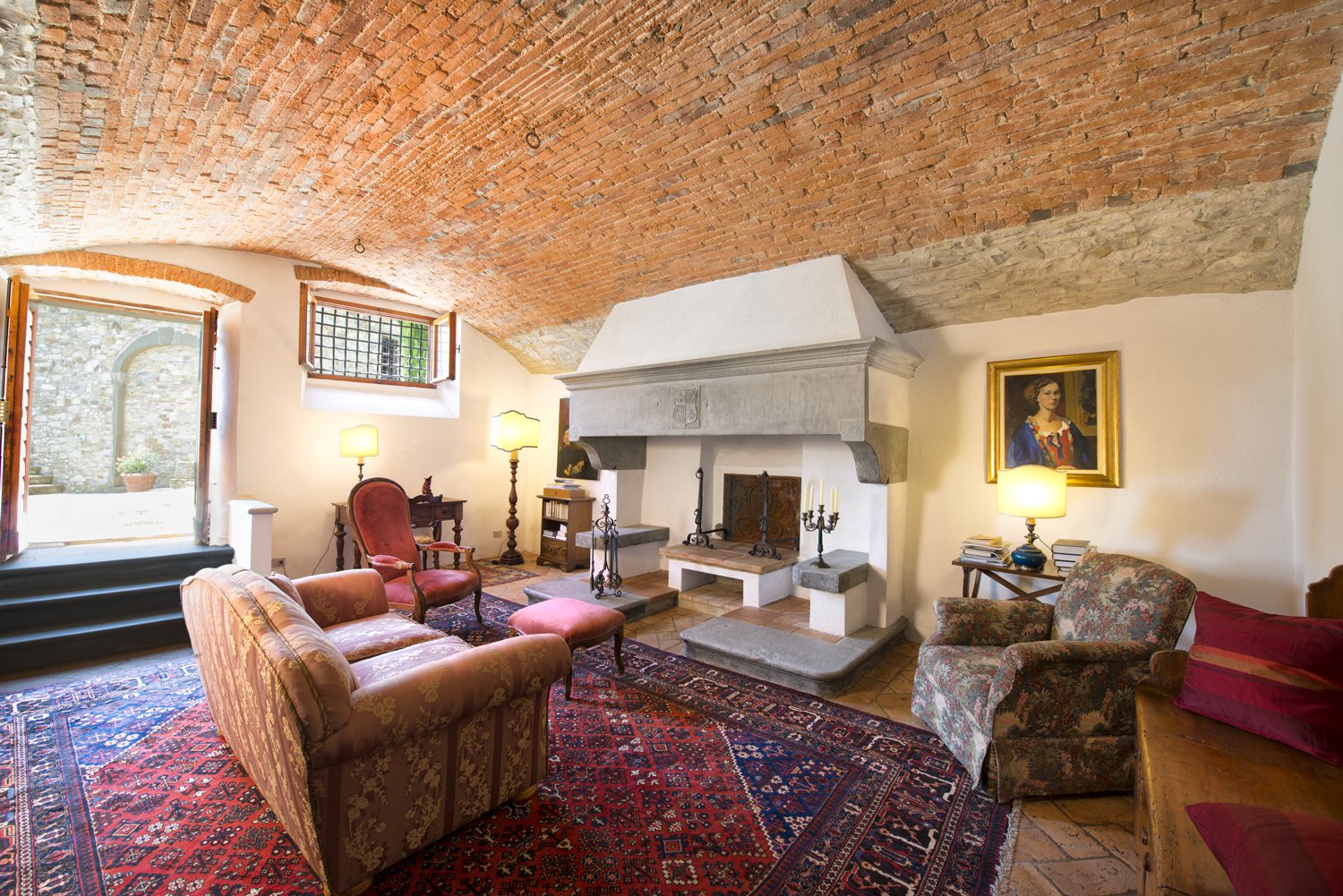 The living room features a brick vaulted ceiling and a stone fireplace with seating nooks.