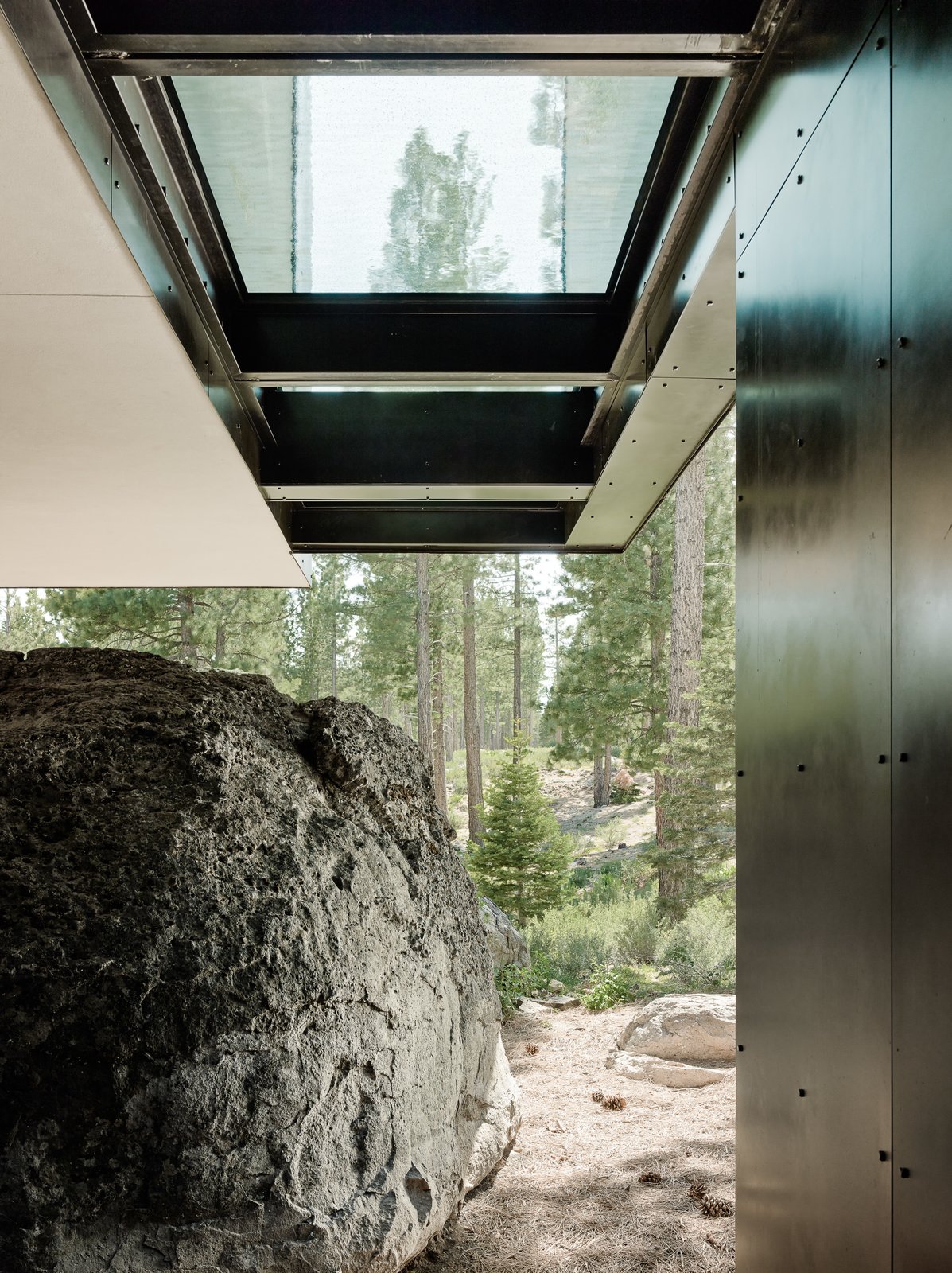 The home cantilevers out over a giant boulder which was found on-site and incorporated into the design.