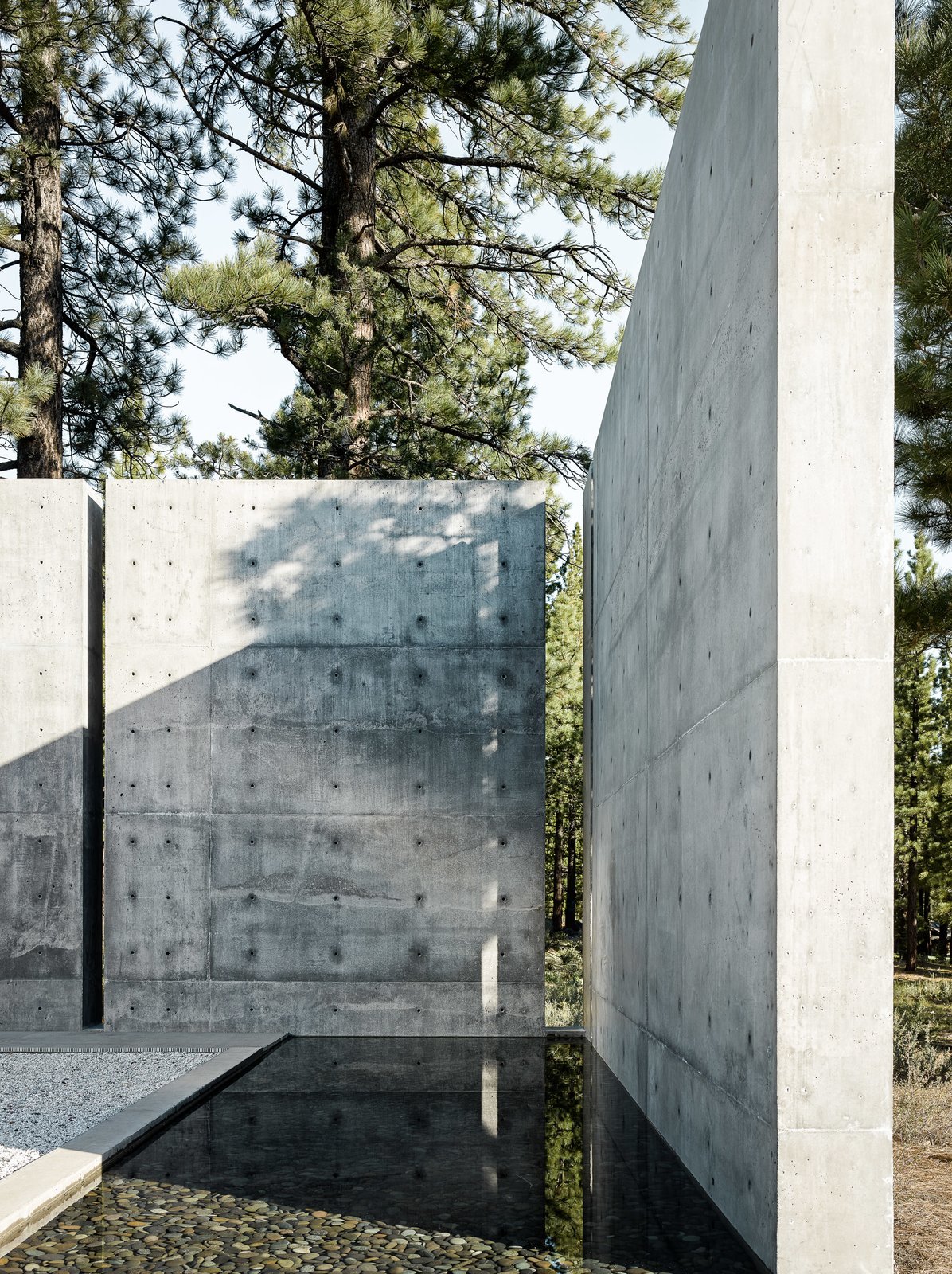 Gaps in the concrete walls leave a glimpse into the natural surroundings.