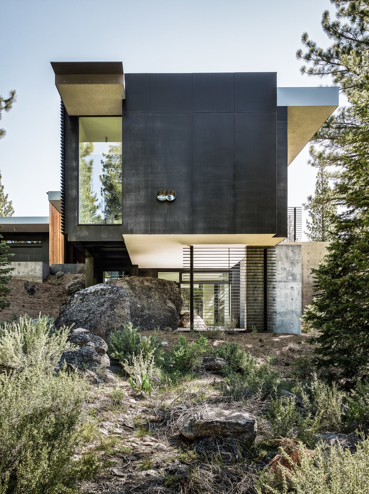 Throughout the site, the original bolders that have been left untouched are evident as the home engulfs them into its design.