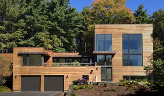 While the homeowners initially hoped to renovate and add on to their original home, a review of multiple renovation strategies revealed that it would be less expensive and less time-consuming to start from scratch and use a custom-designed prefab.